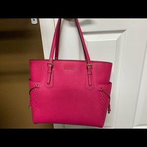 Michael Kors large pink tote with gold cutouts.